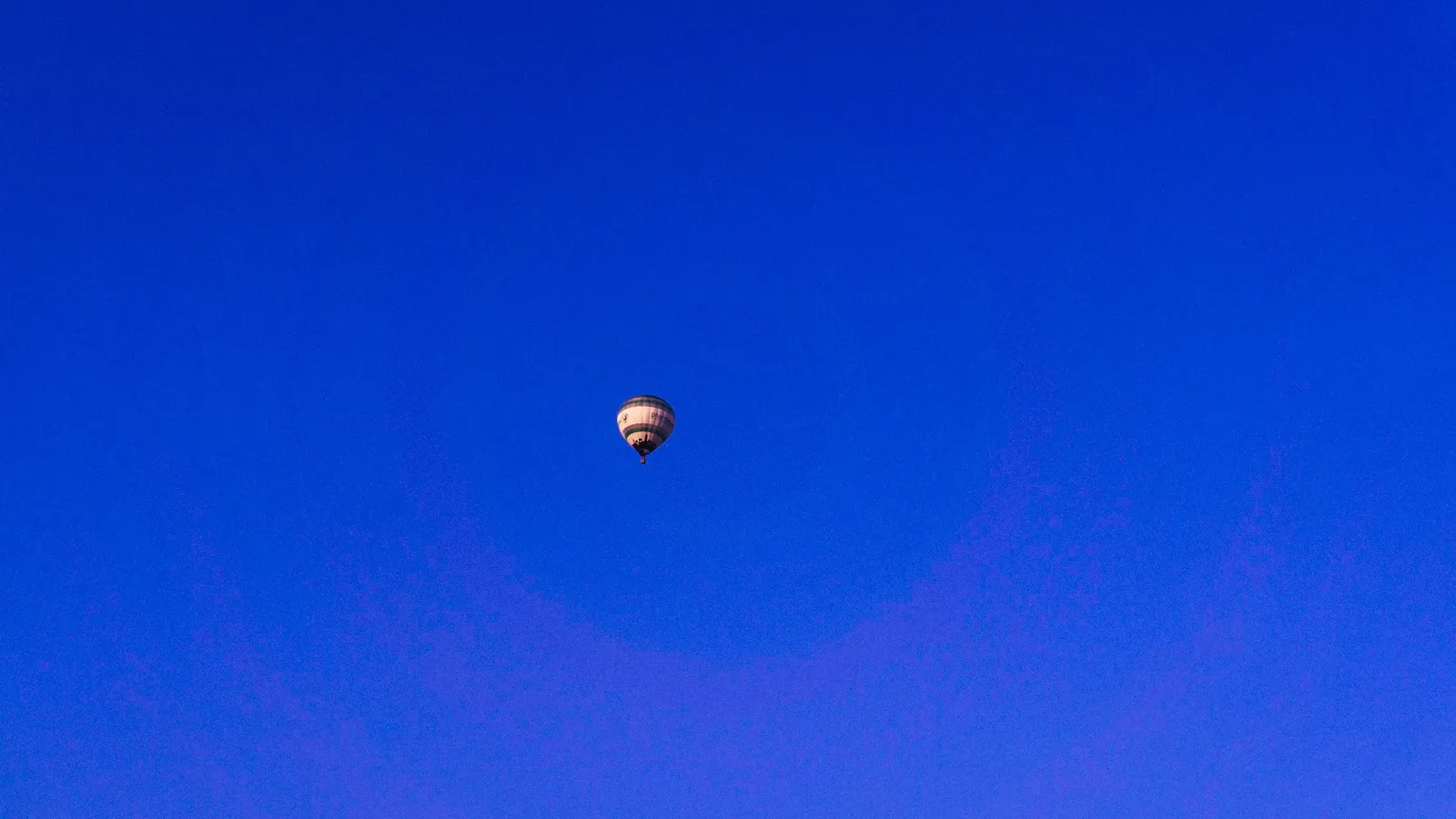 A ball high up against a clear blue sky