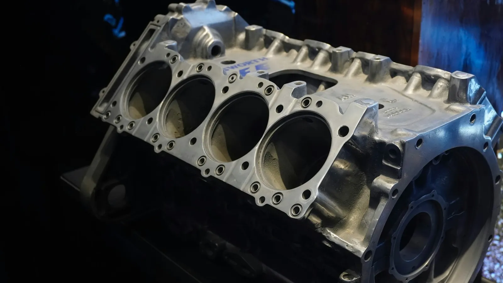 A bare engine block showing its empty cylinders