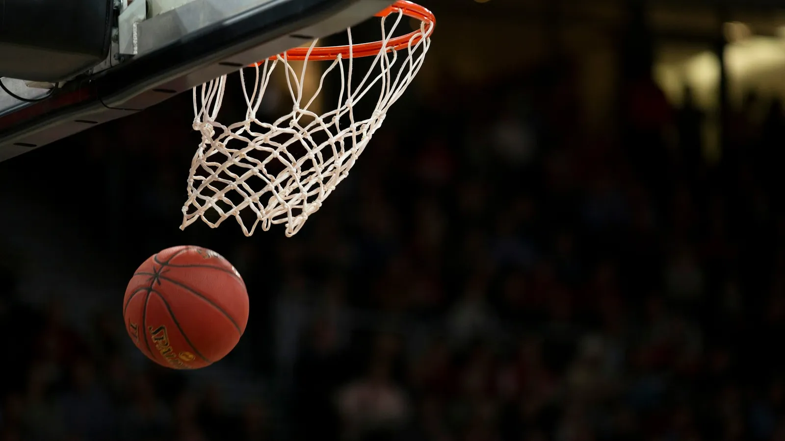 A basketball dropping through a hoop