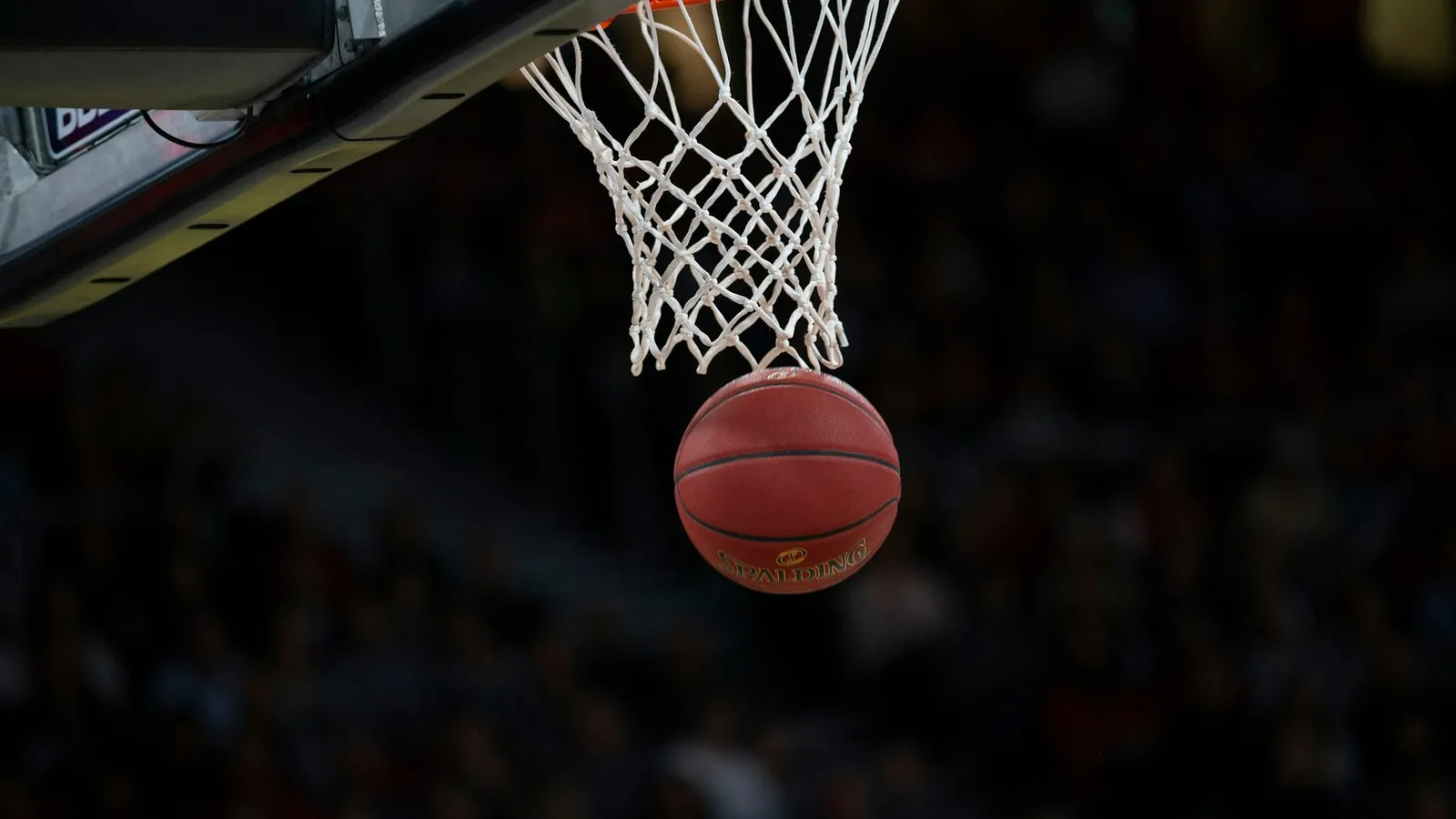 A basketball dropping through the hoop
