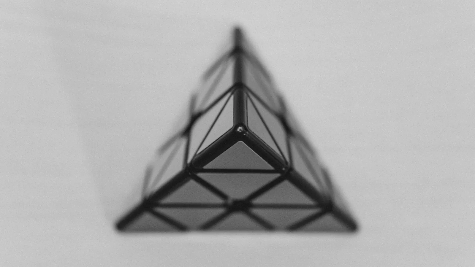 A black tetrahedron shape on a white background