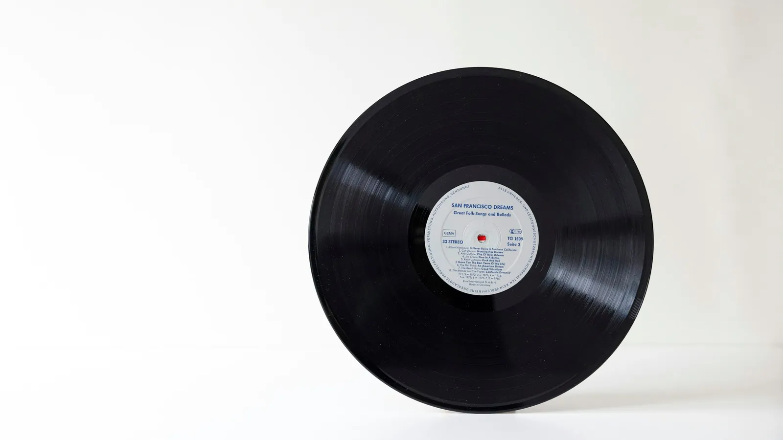 A black vinyl record on a white background