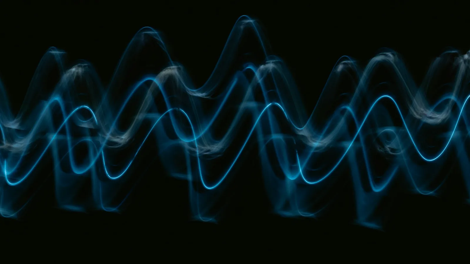 A blue wave of light against a dark background
