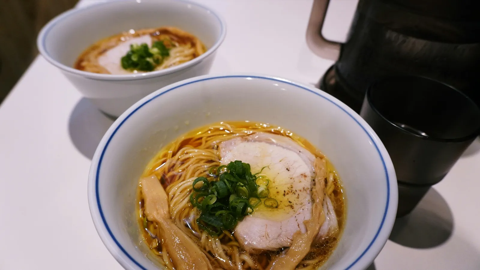 A bowl of noodles in clear broth