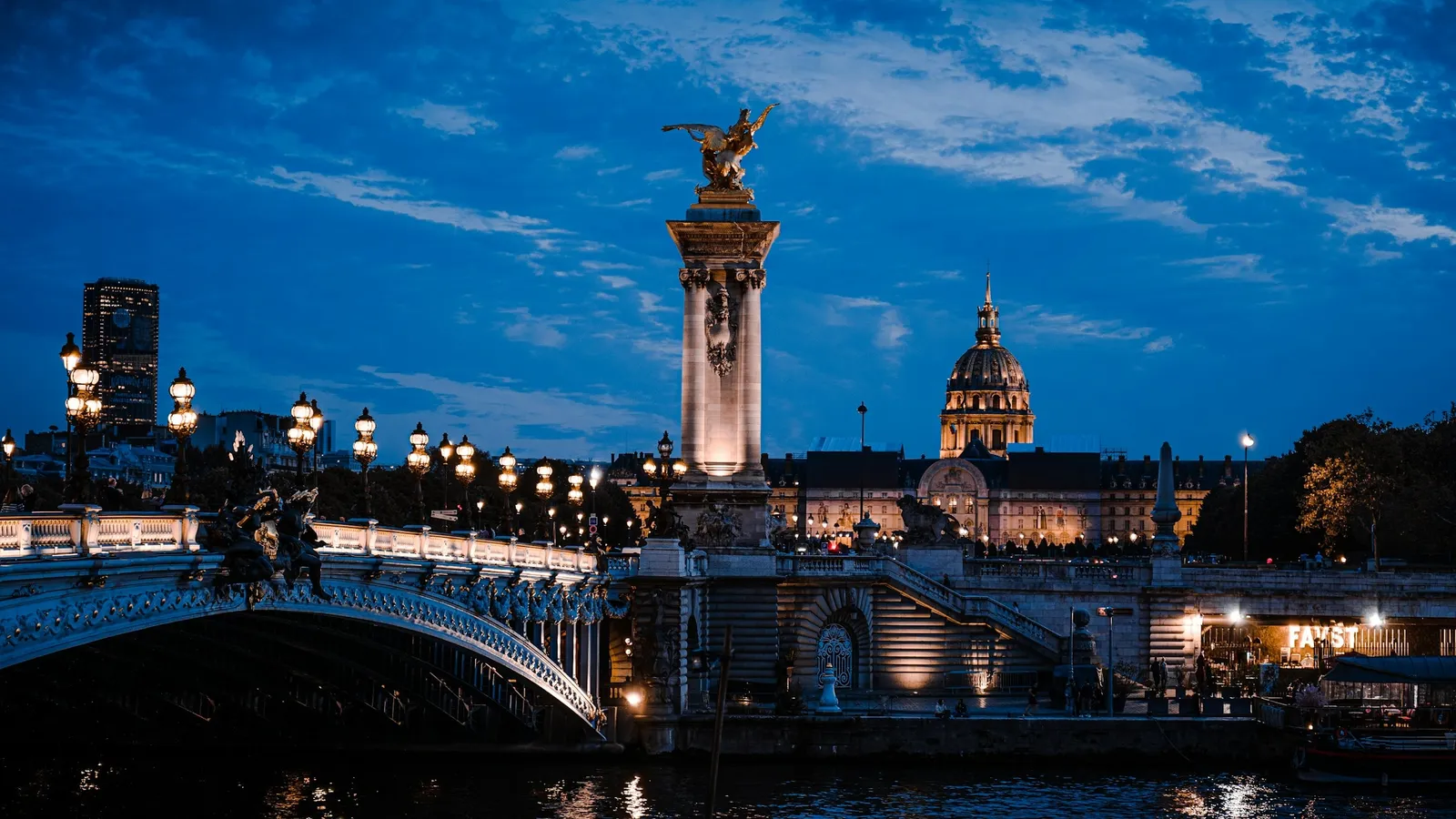 A bridge over the Seine in Paris lit up at dusk