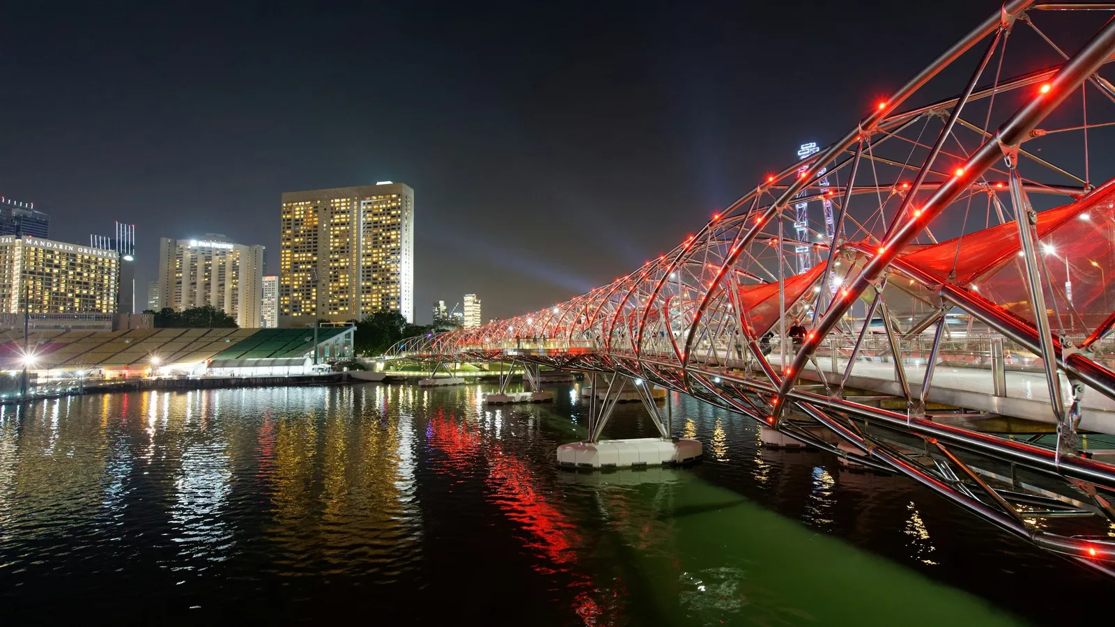 A bridge shaped like a DNA double helix, lit up at night