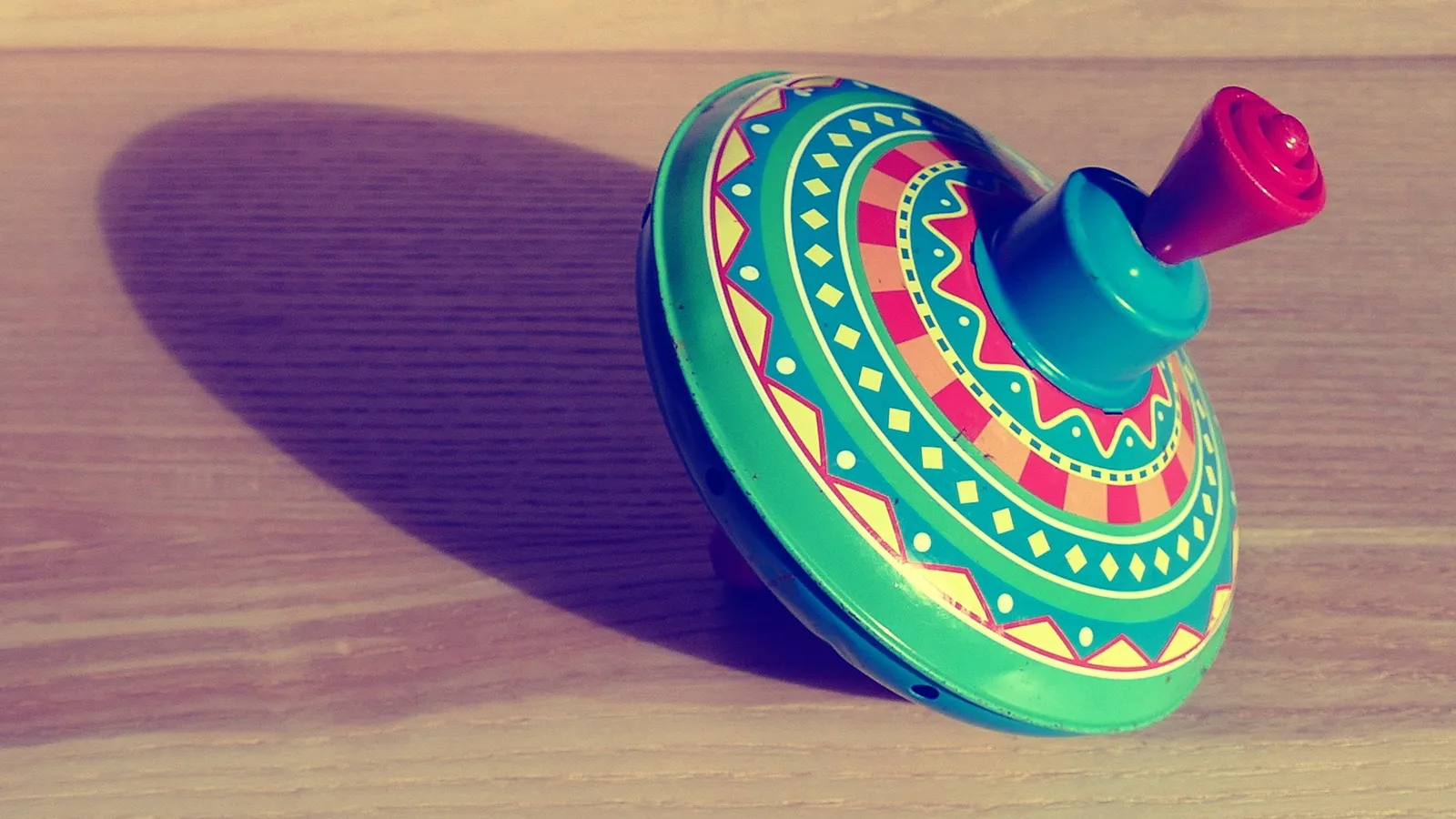 A brightly painted spinning top on a table
