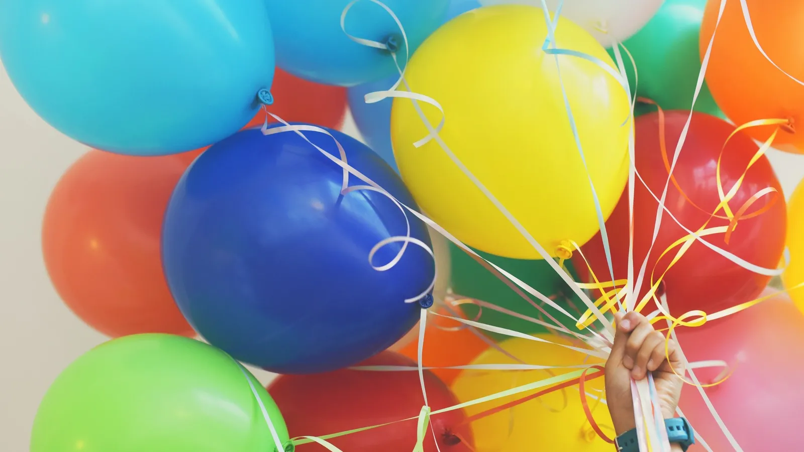 A bunch of colourful balloons held together