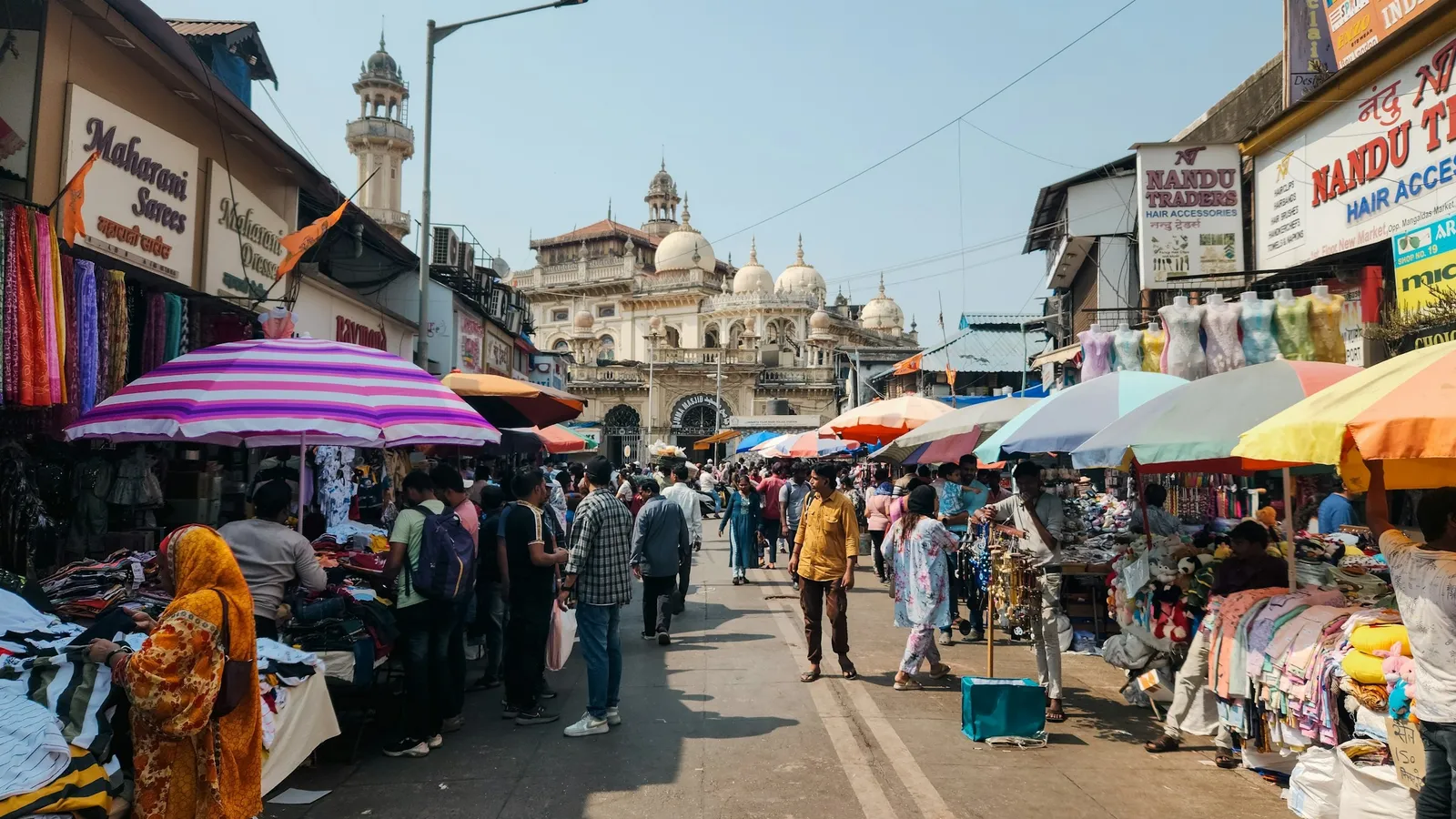A busy Indian market street with stalls and shoppers
