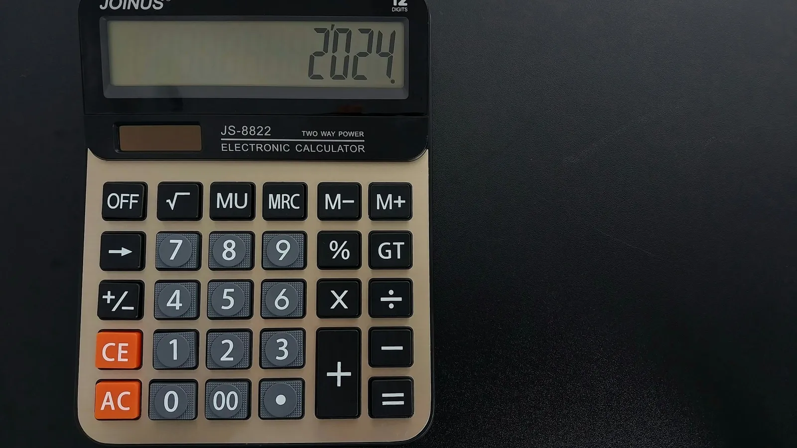 A calculator on a dark table