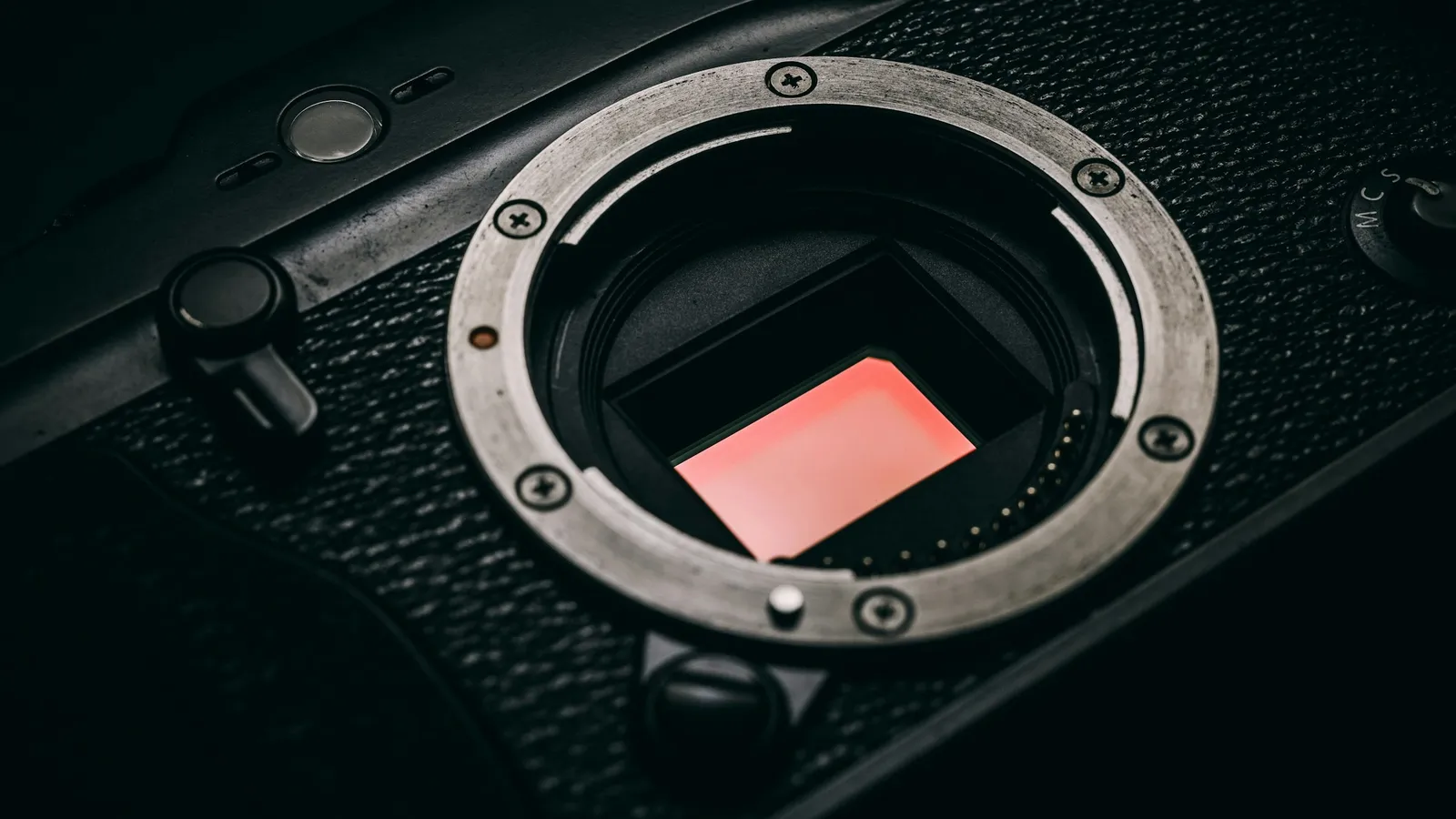 A camera body with the lens removed, showing its image sensor