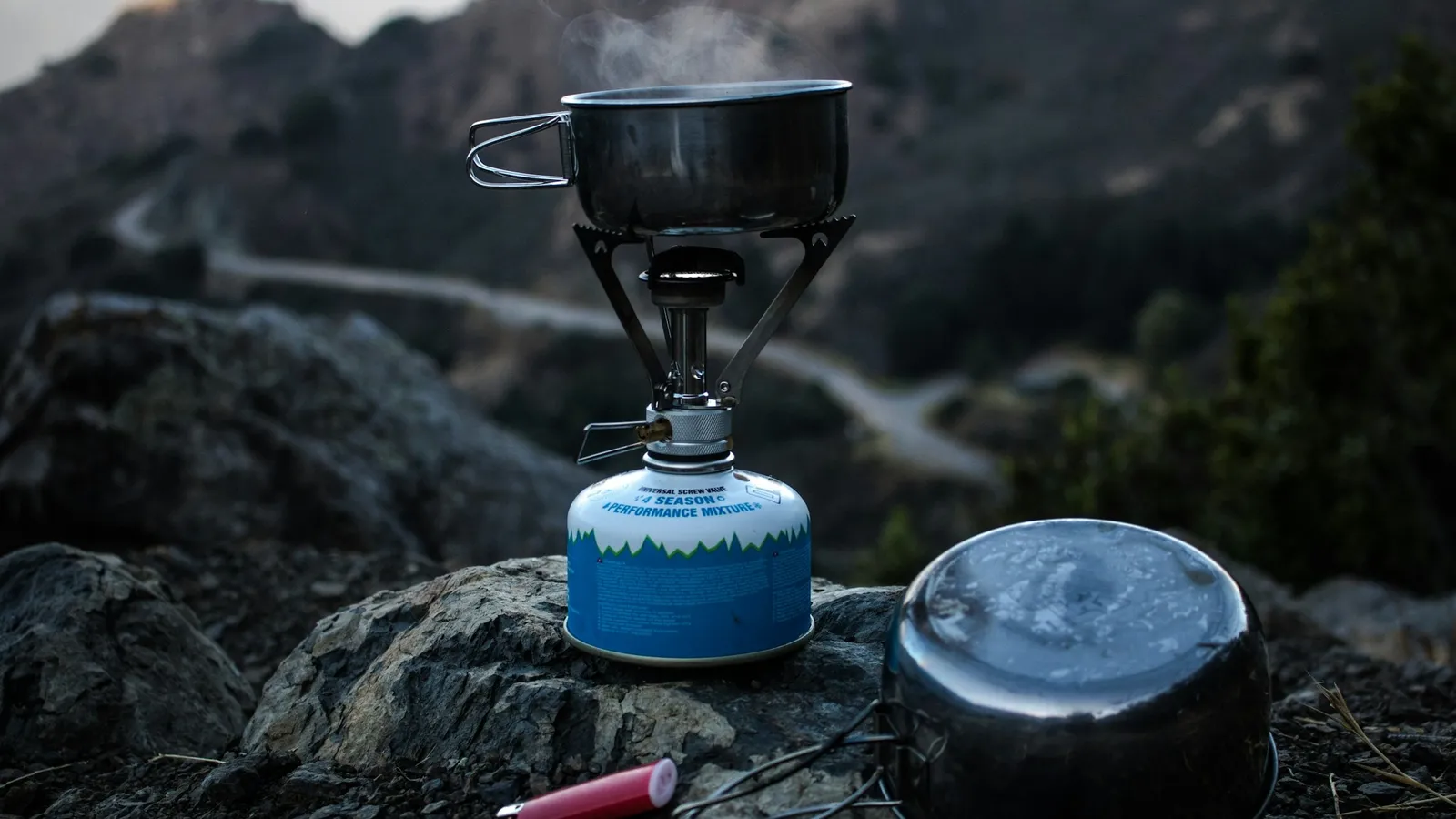 A camping gas stove on a rock