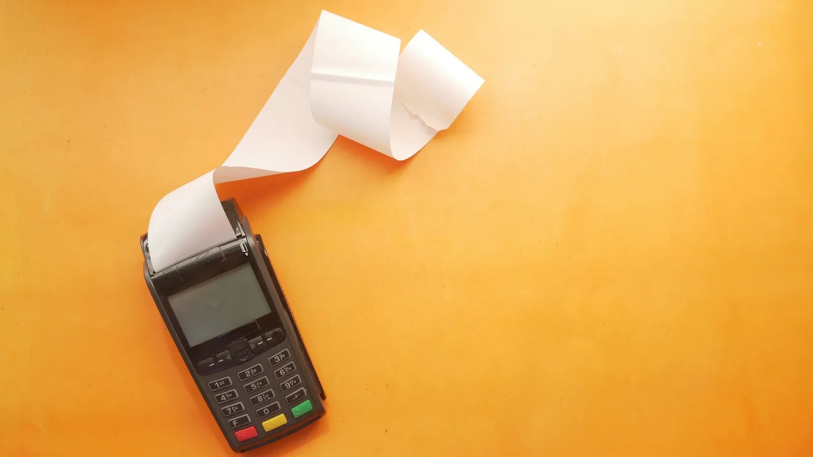 A card payment machine with a long printed receipt