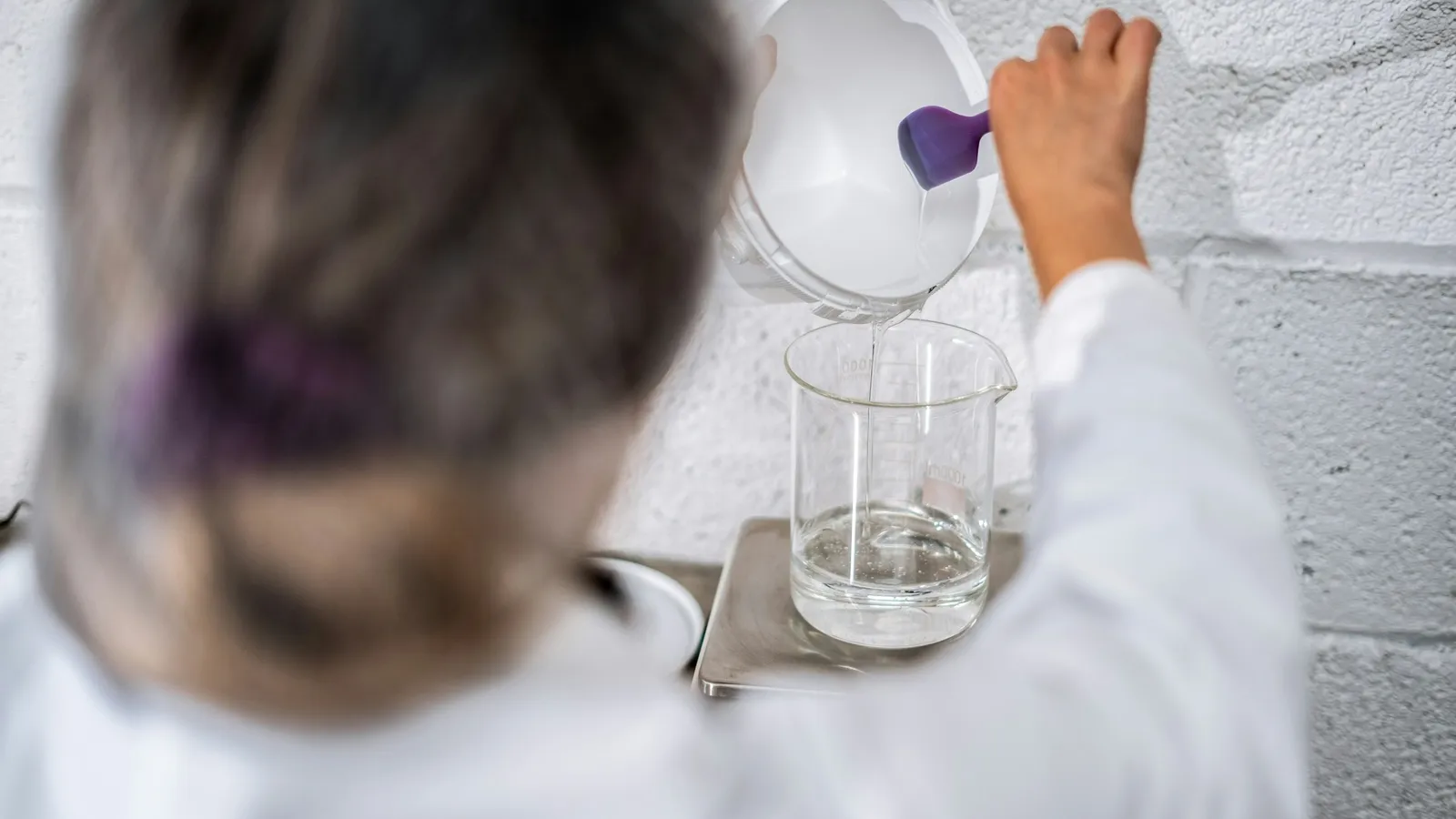 A child pouring liquid during a science experiment