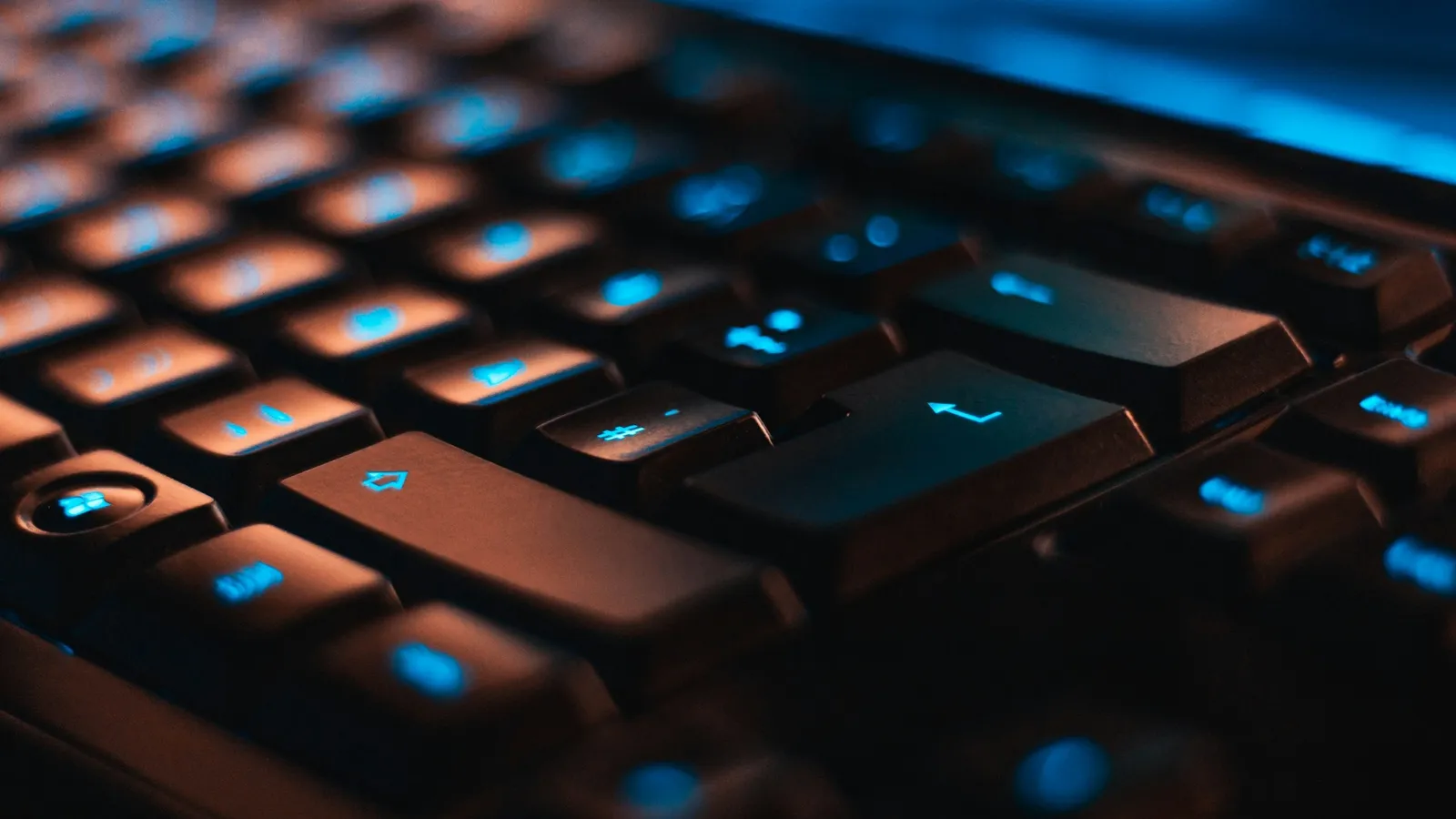 A close-up of a backlit computer keyboard