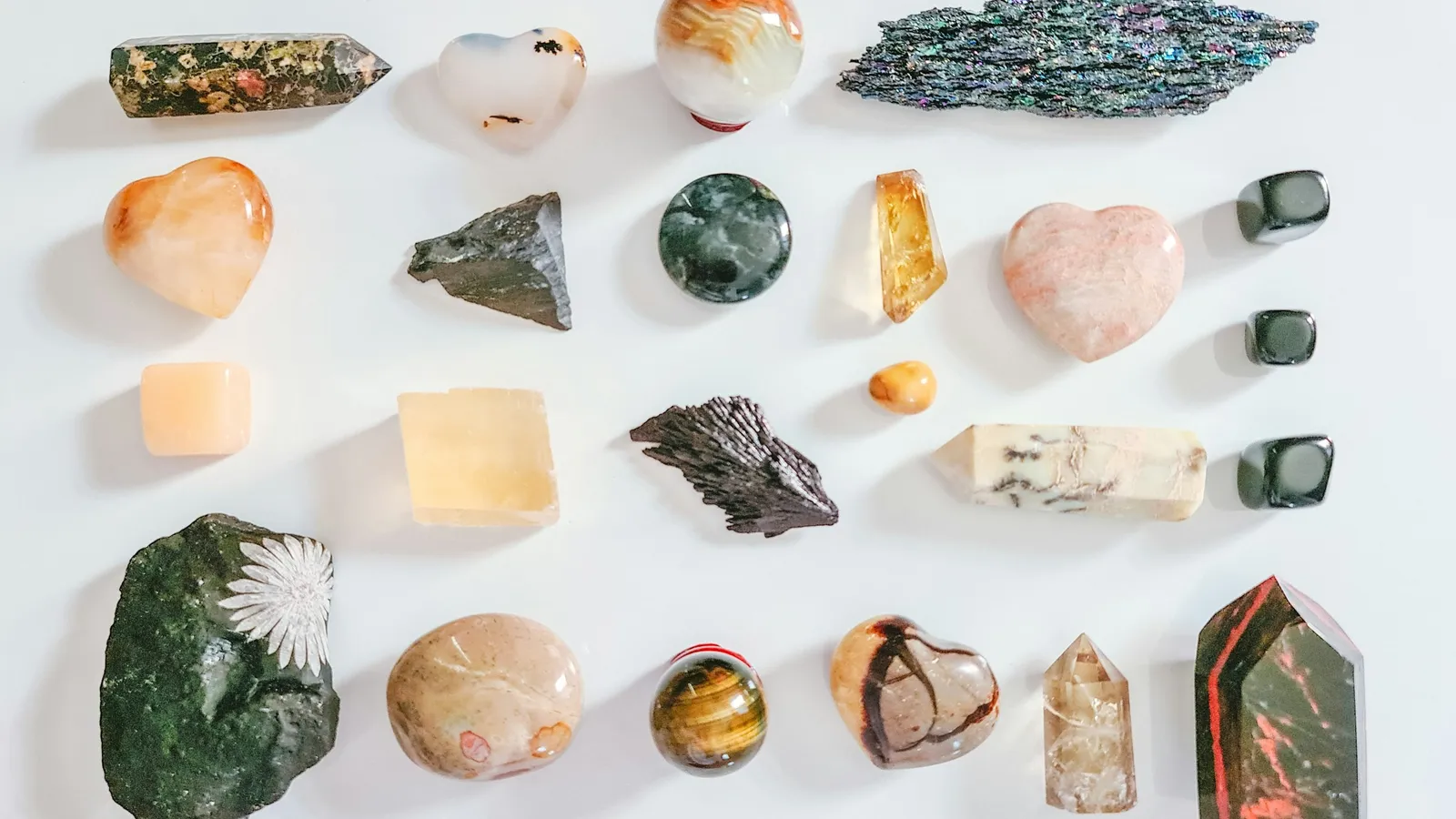 A collection of different minerals laid out on white