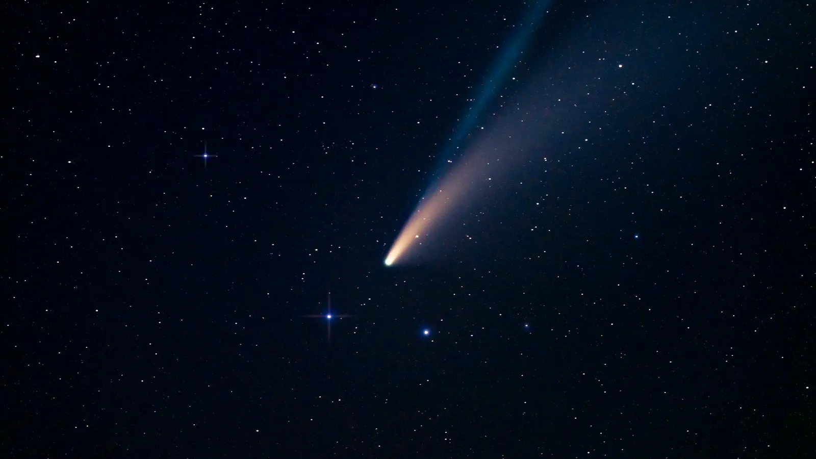A comet with a long tail in a starry sky