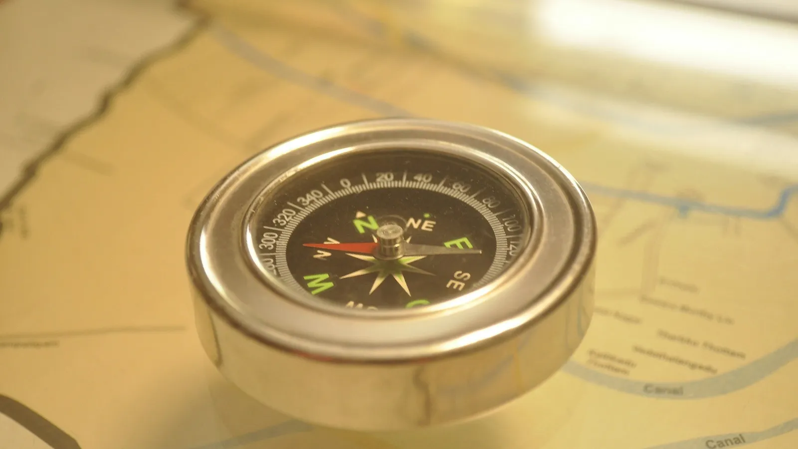 A compass resting on an old map