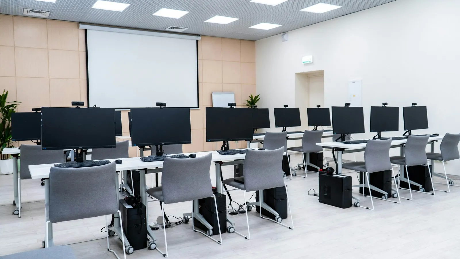 A computer-based test hall with rows of desktop computers