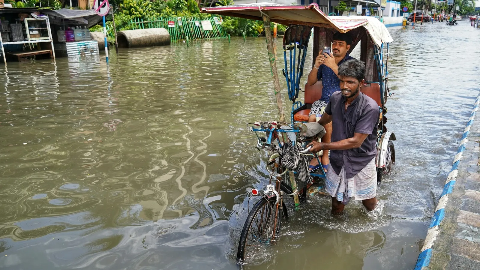A cycle rickshaw on a flooded street in the monsoon