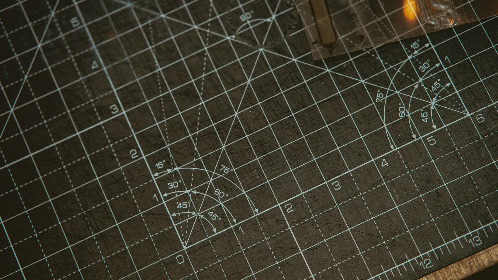 A dark cutting mat marked with crossing grid lines