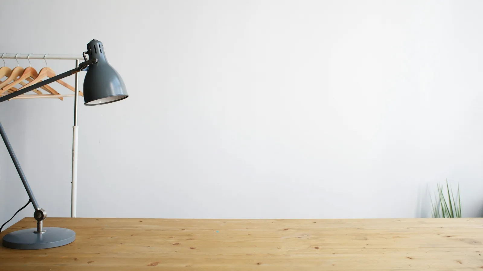A desk lamp on an empty wooden study table