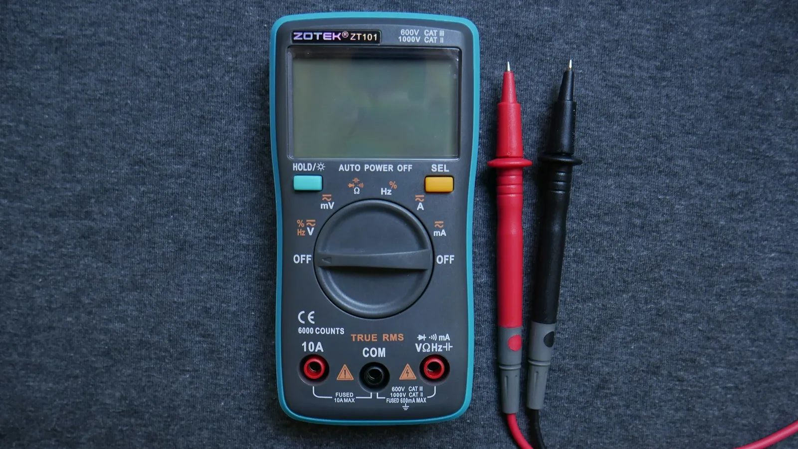 A digital multimeter with red and black test leads