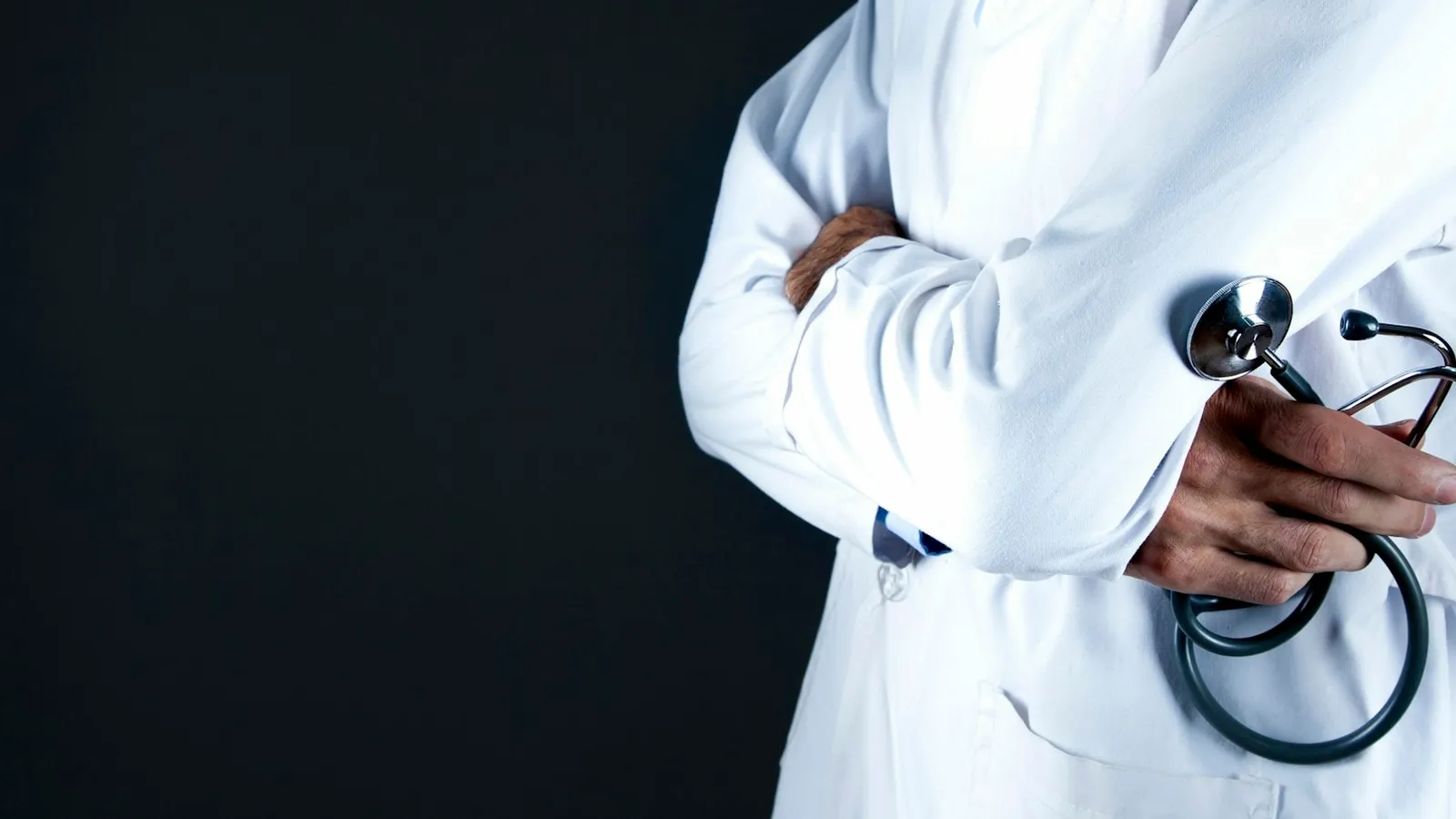 A doctor in a white coat holding a stethoscope