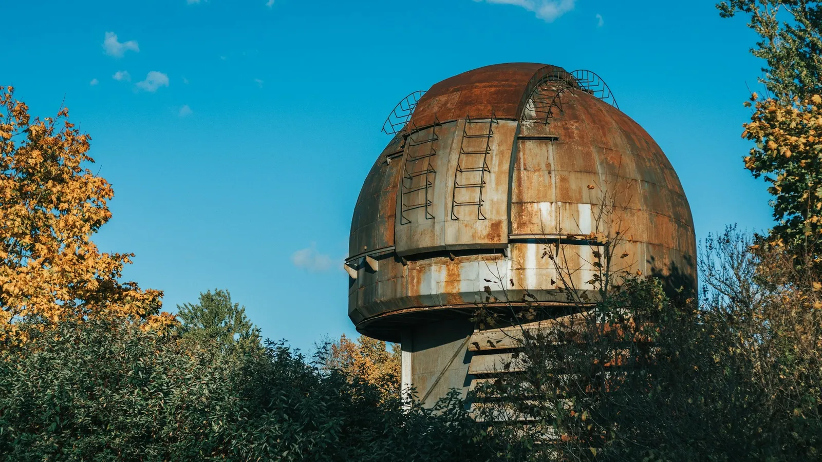 A domed observatory among autumn trees