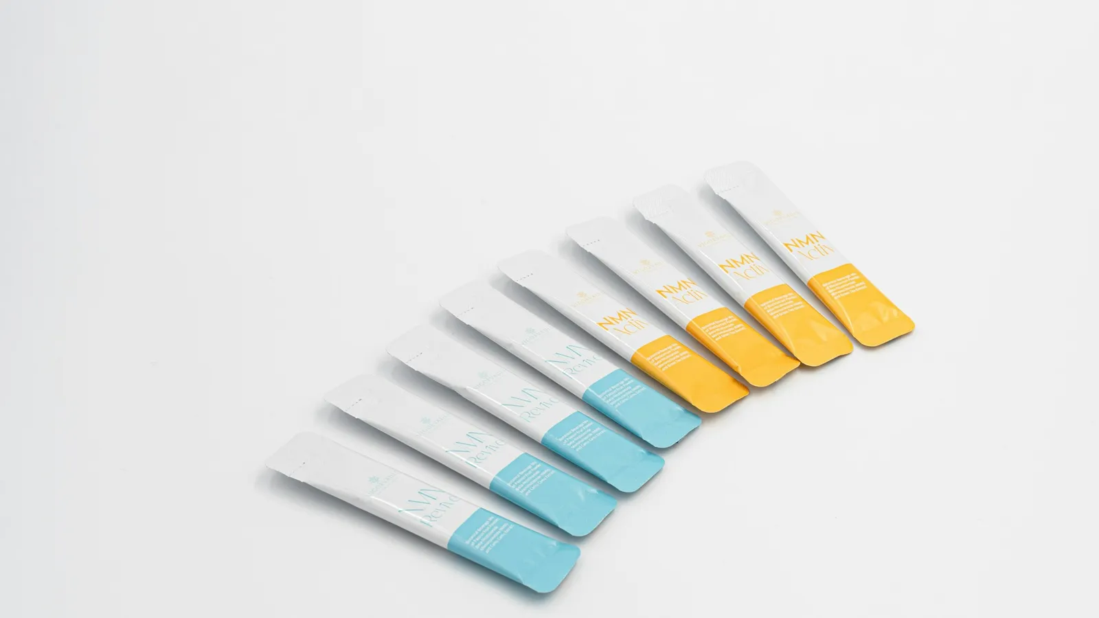 A fan of pH test strips with coloured pads on a white surface