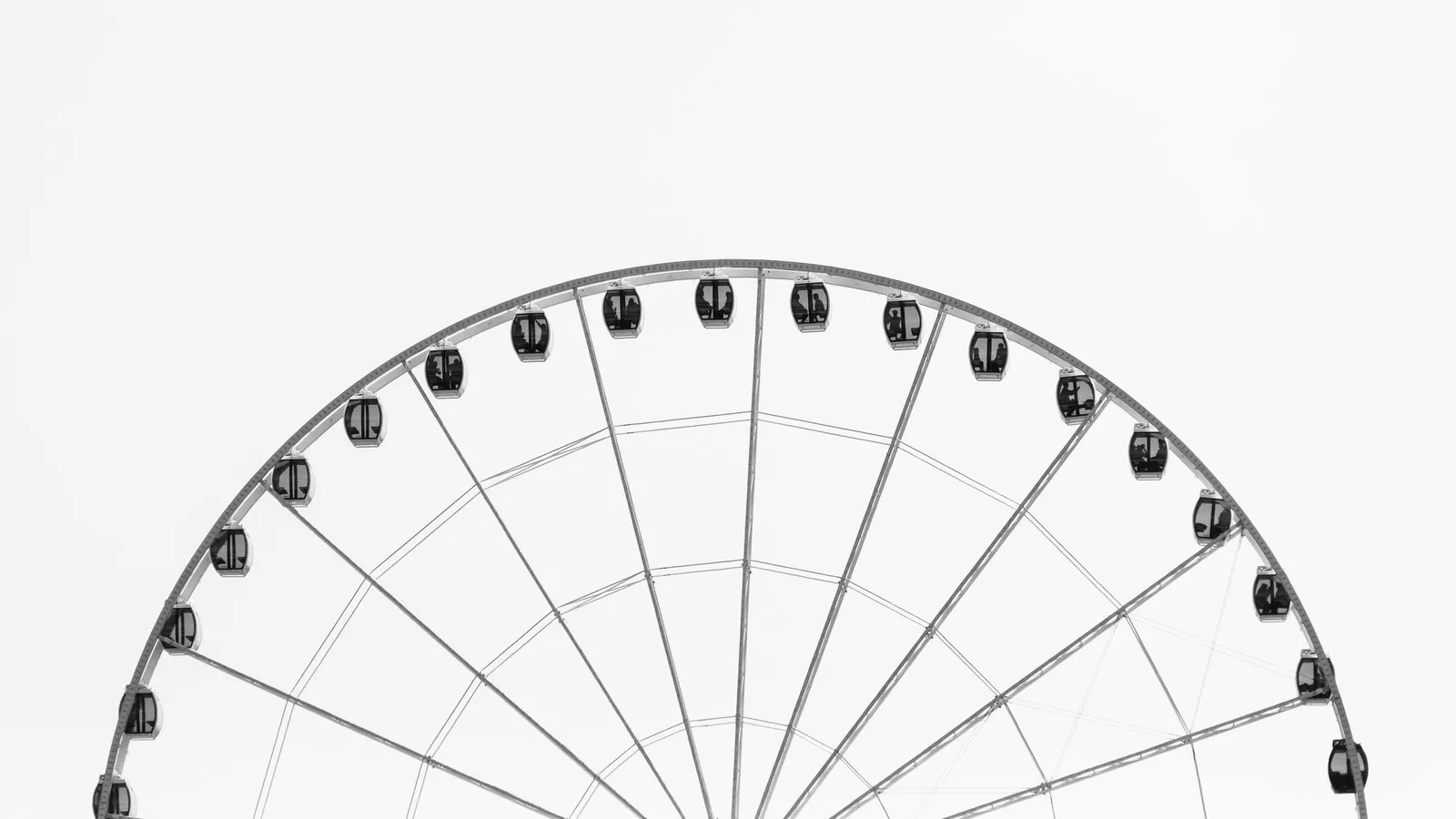 A Ferris wheel outline against a white sky