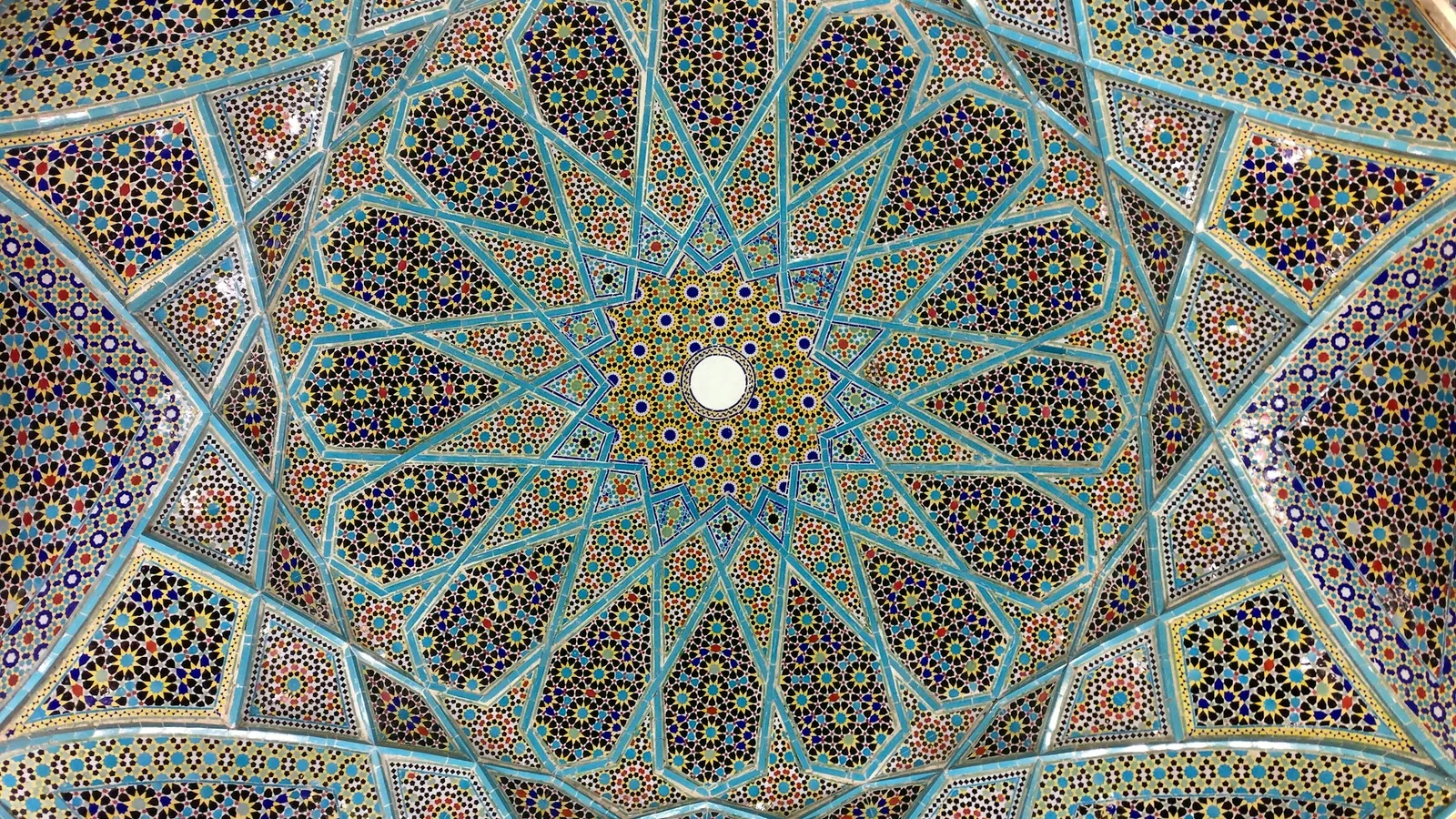 A geometric star pattern on a tiled dome ceiling
