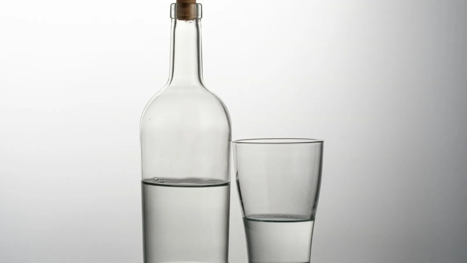A glass bottle and a glass of clear water