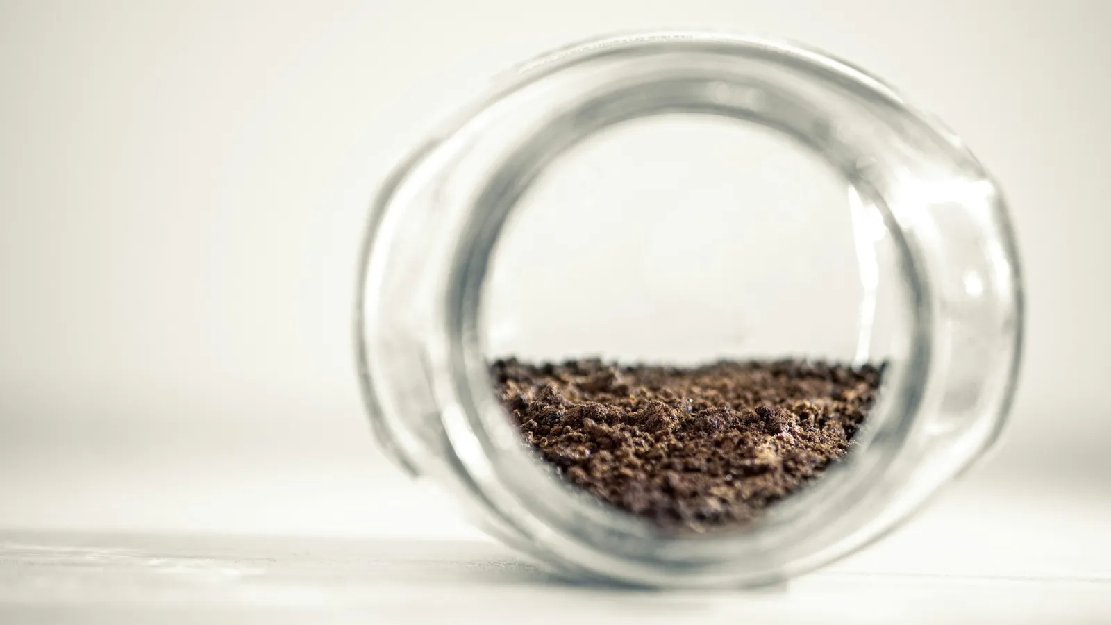 A glass jar holding a soil sample