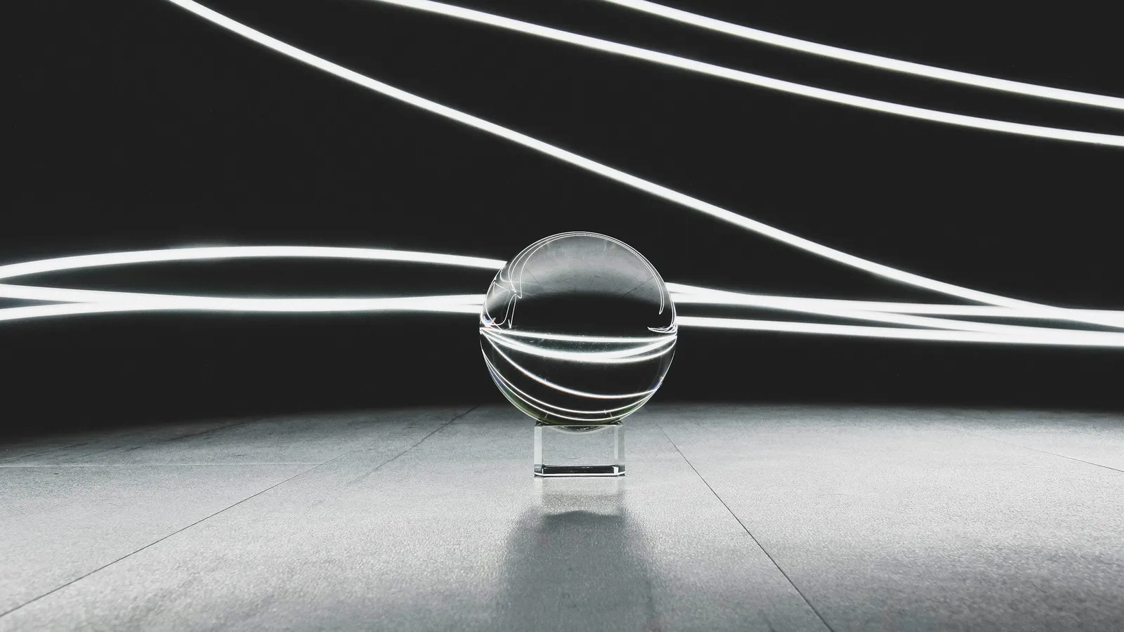 A glass sphere resting among curved lines of light