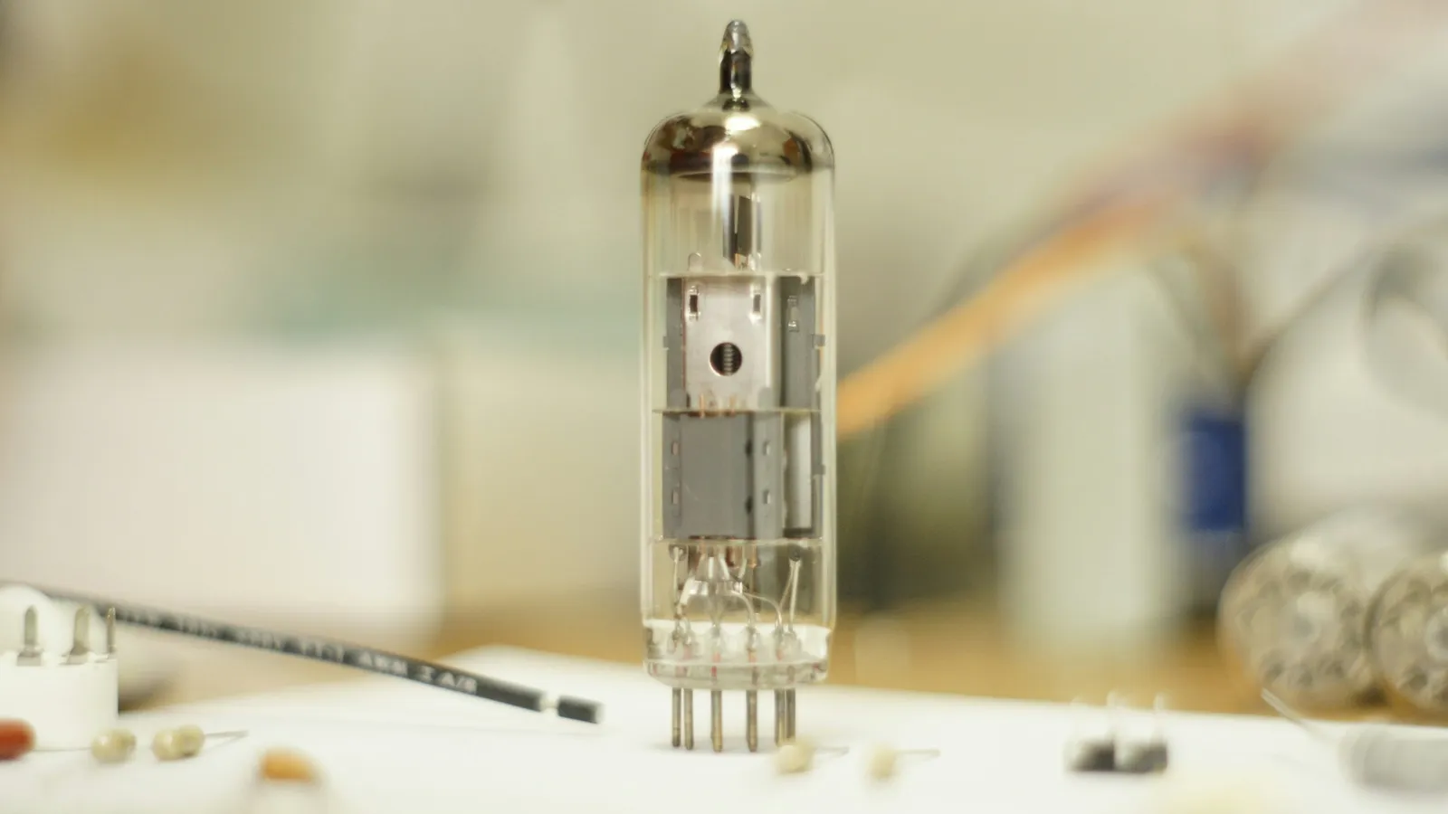 A glass vacuum tube on a workbench
