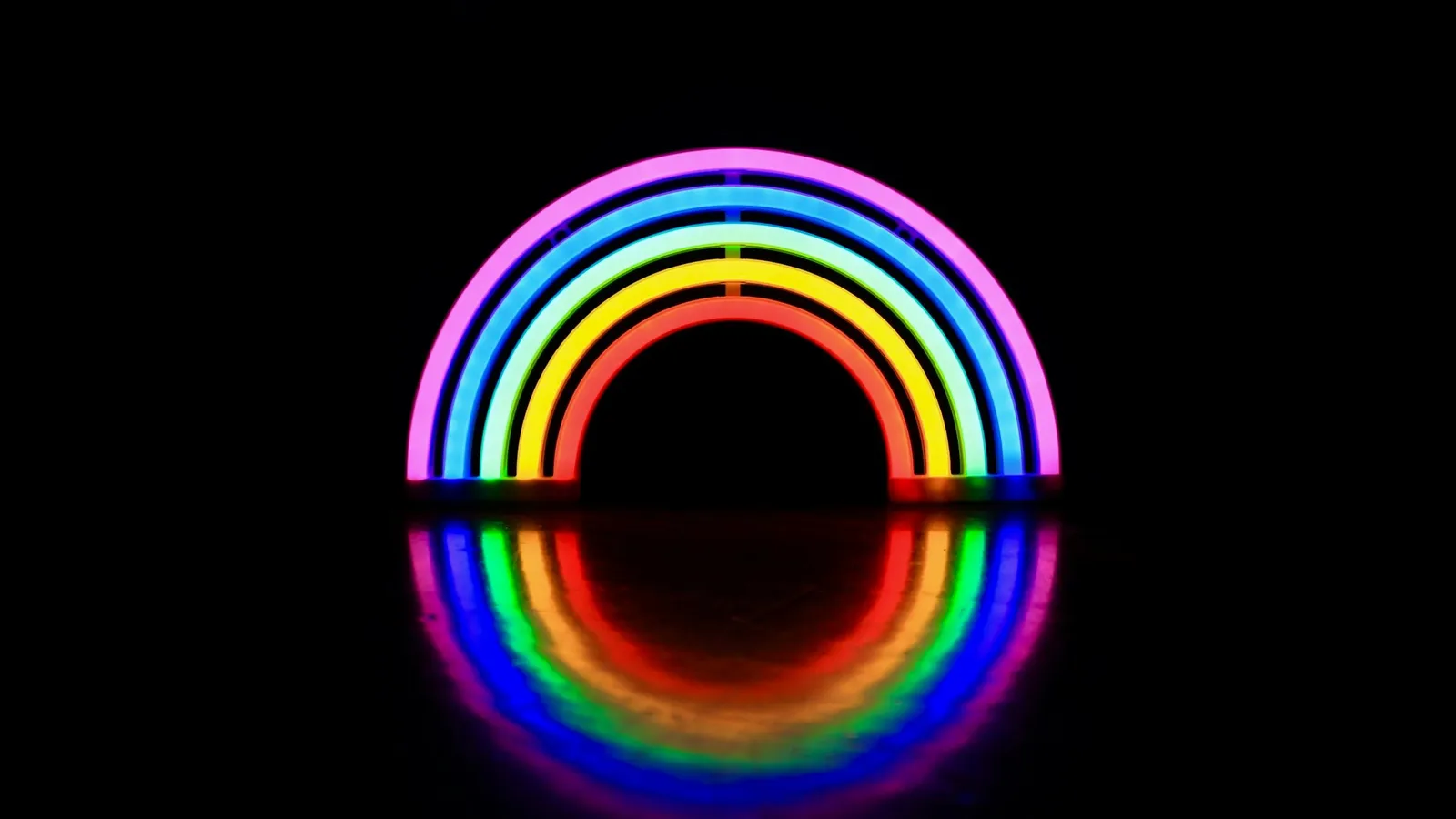 A glowing rainbow-coloured neon arc