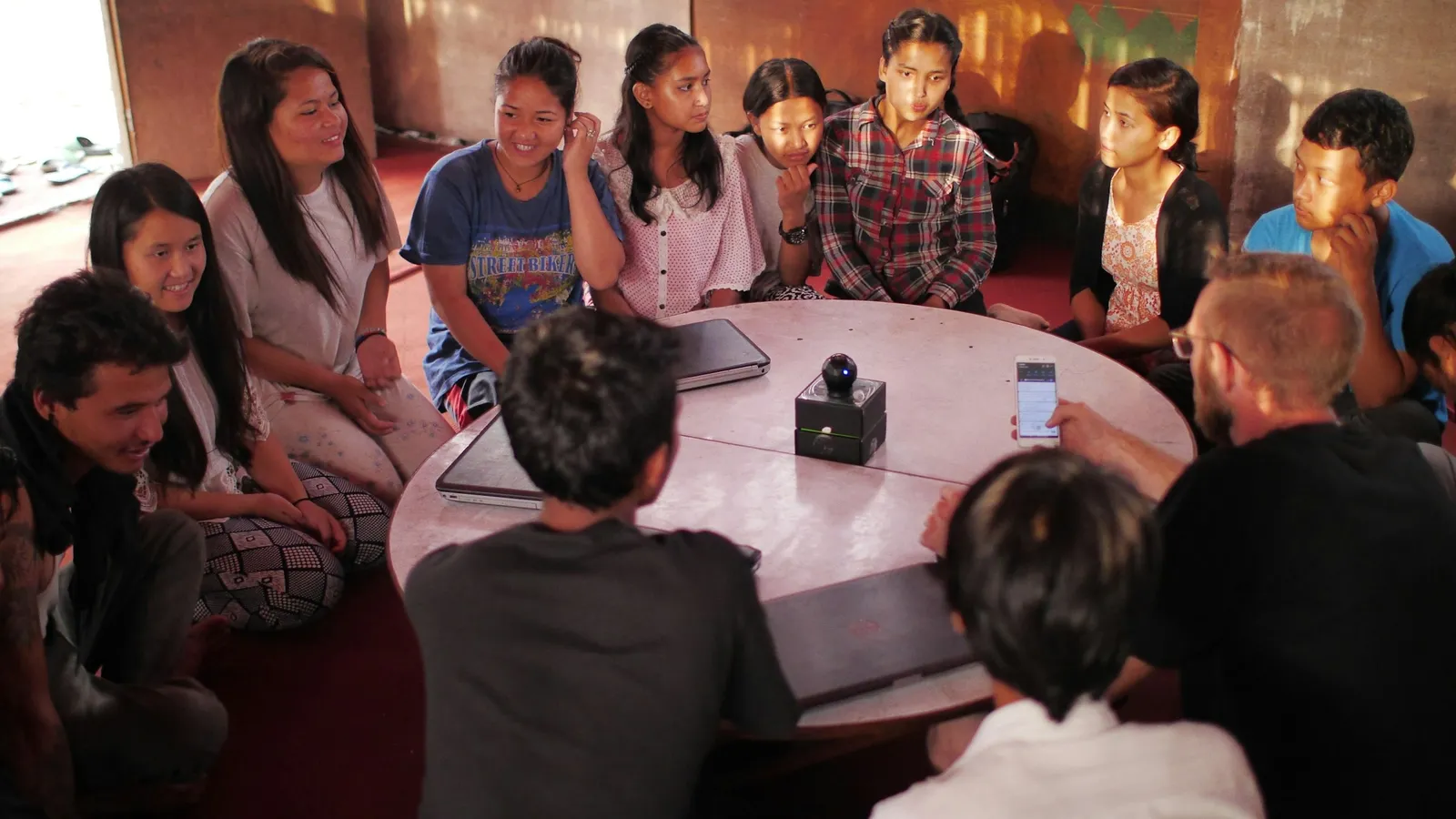 A group of students talking together around a table