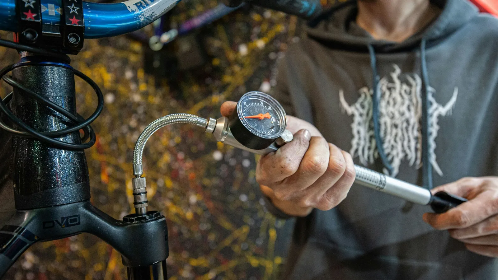 A hand holding a pump with a pressure gauge
