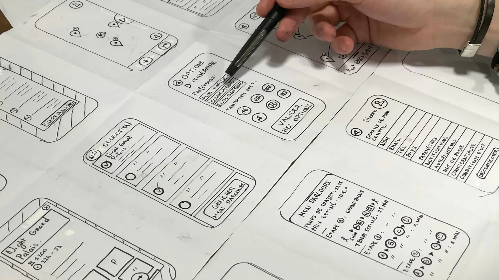 A hand sketching design ideas on paper