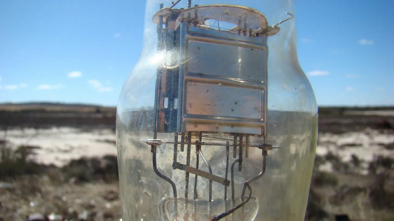 A large glass vacuum tube held up outdoors