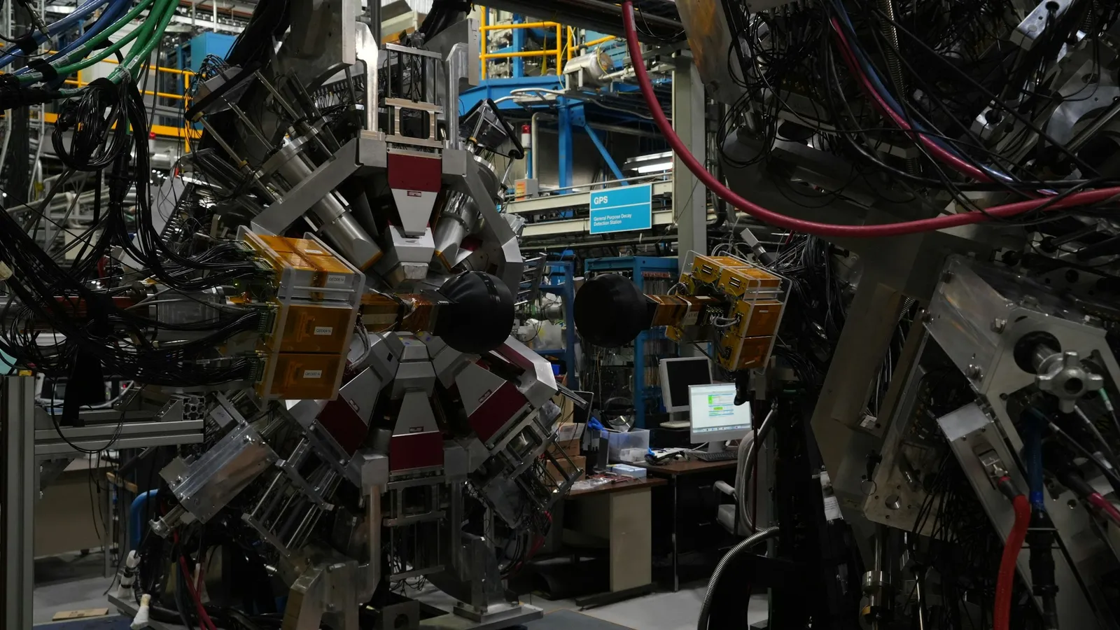 A large physics experiment crowded with instruments and cables
