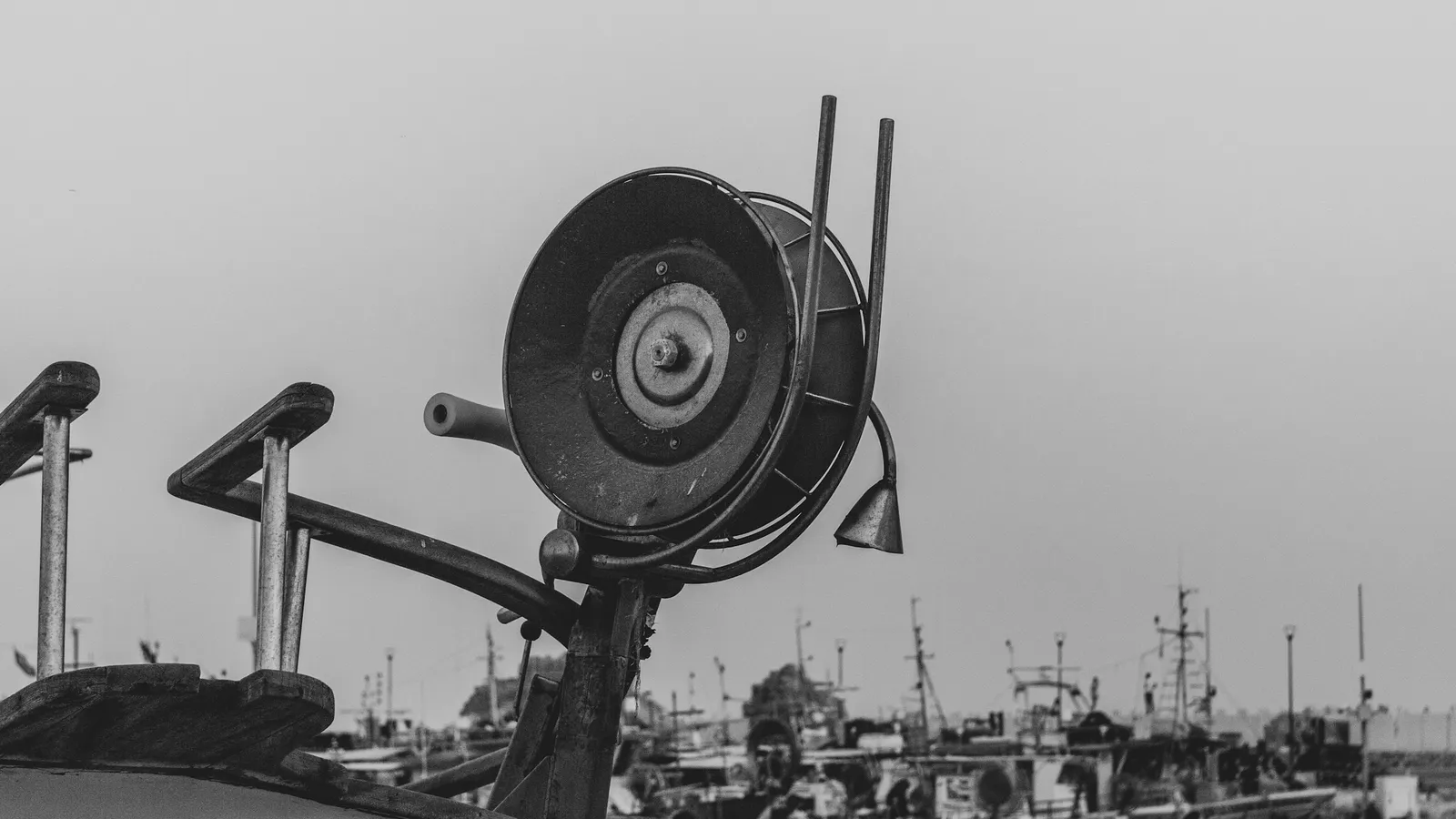 A large radio antenna on a rooftop, in black and white