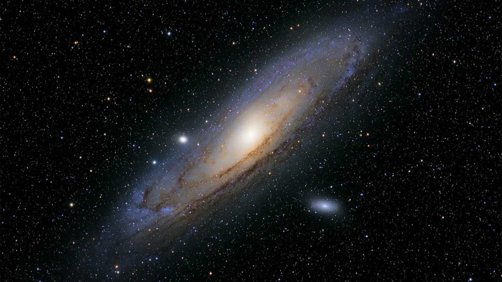 A large spiral galaxy seen at an angle among stars