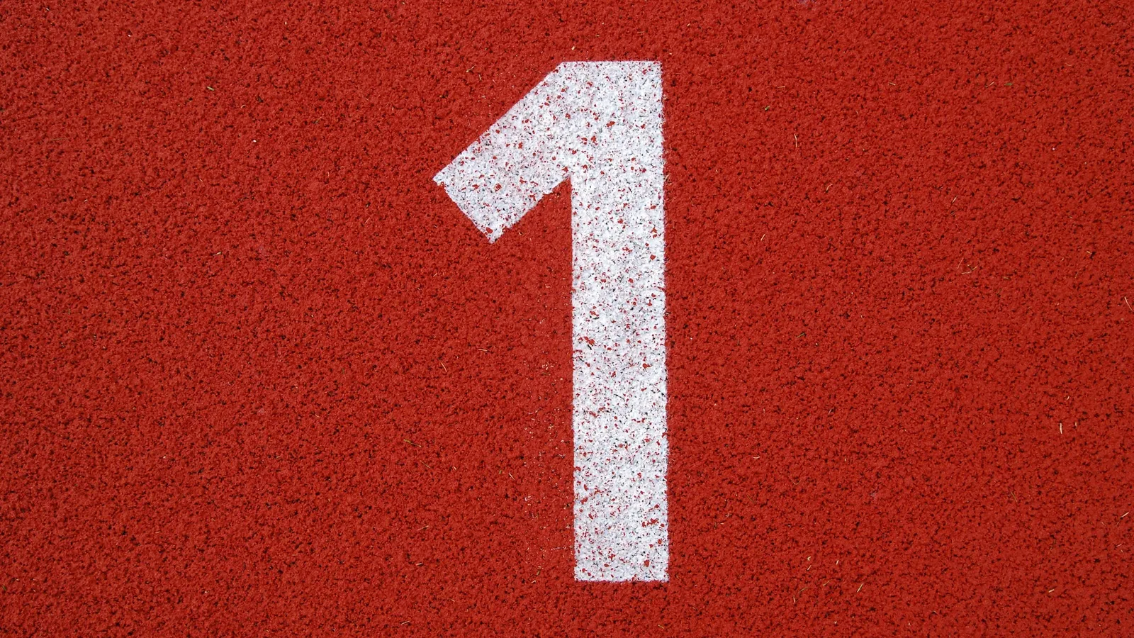 A large white numeral 1 painted on a red surface