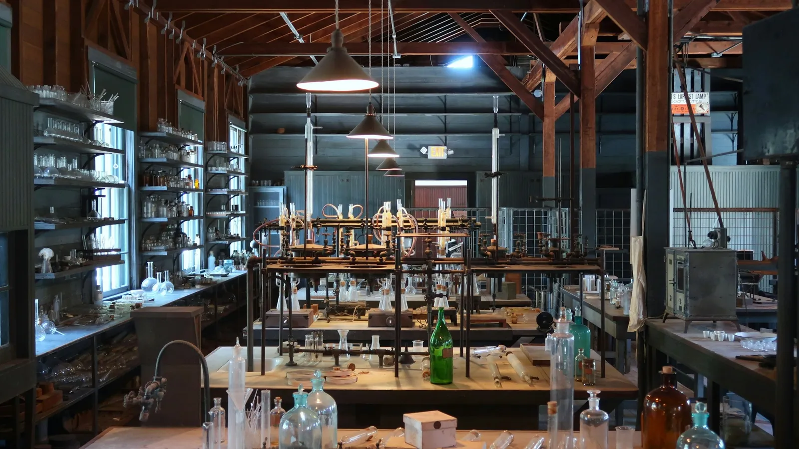 A long old-fashioned laboratory with wooden benches and glassware