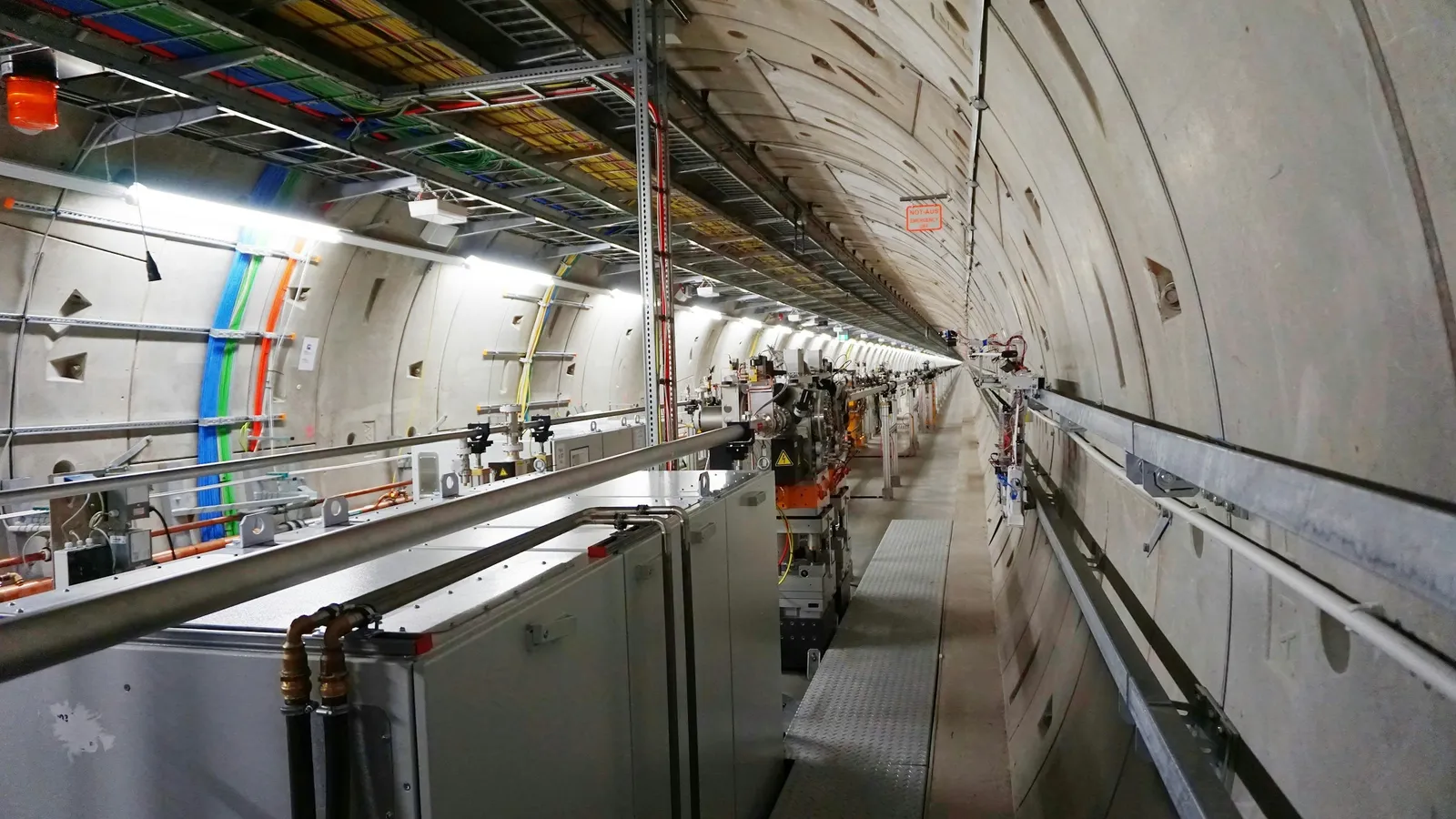 A long particle accelerator tunnel lined with magnets