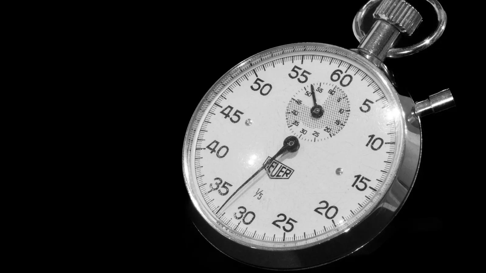 A mechanical stopwatch on a black background