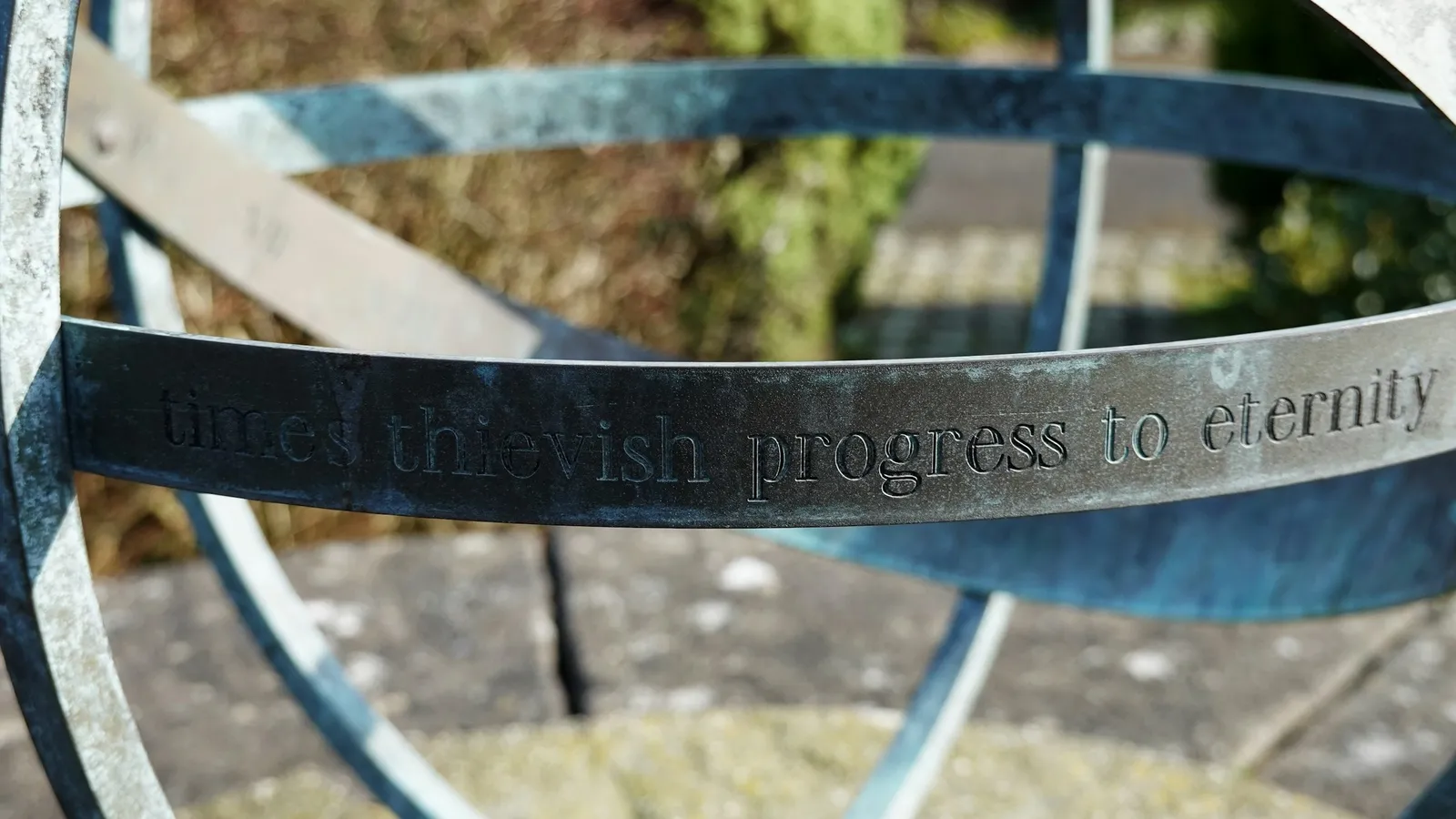 A metal armillary sphere sundial in a garden