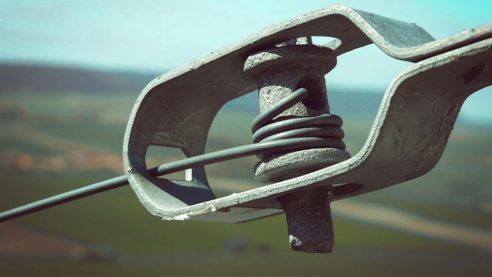 A metal clamp gripping a wire